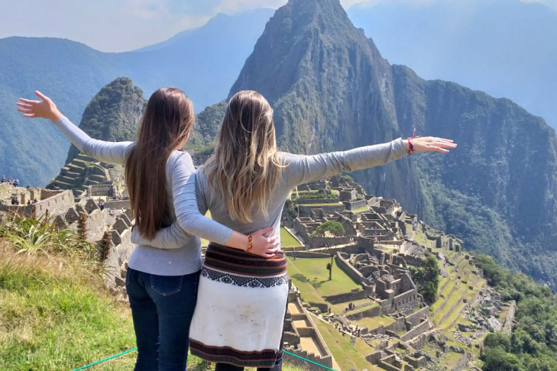 Two friends pose for a picture in Machu Picchu