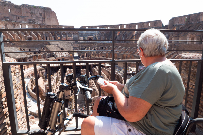 A man in a wheelchair explores the Colosseum