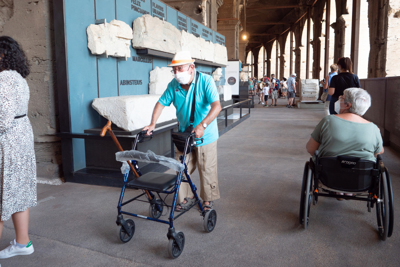 A man with a walker explores the Colosseum