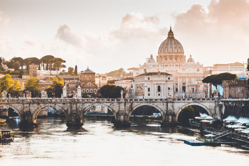 A view of Rome's skyline, with the Dome of Saint Peter's Cathedral and a bridge across the River Tiber
