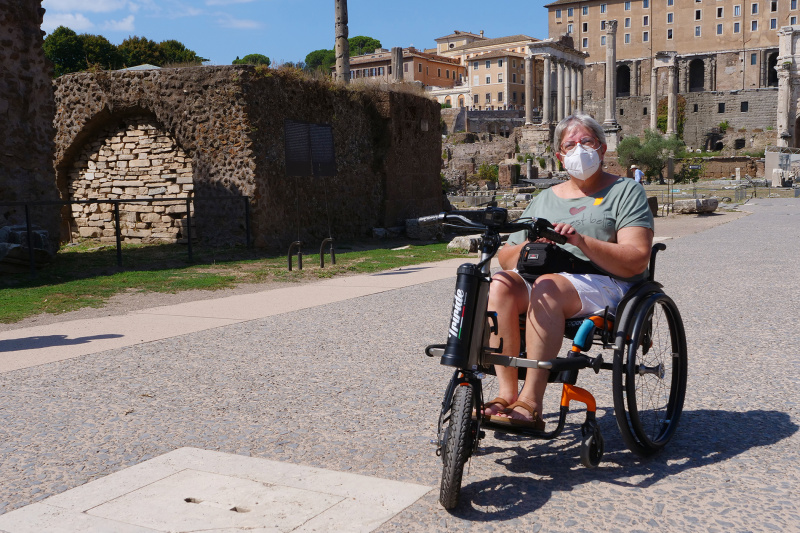 A person in an adapted wheelchair inside the Roman Forum