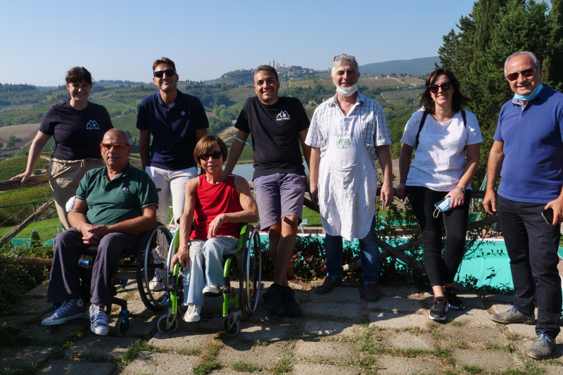 The tour group poses for a photo in the scenic Tuscan countryside