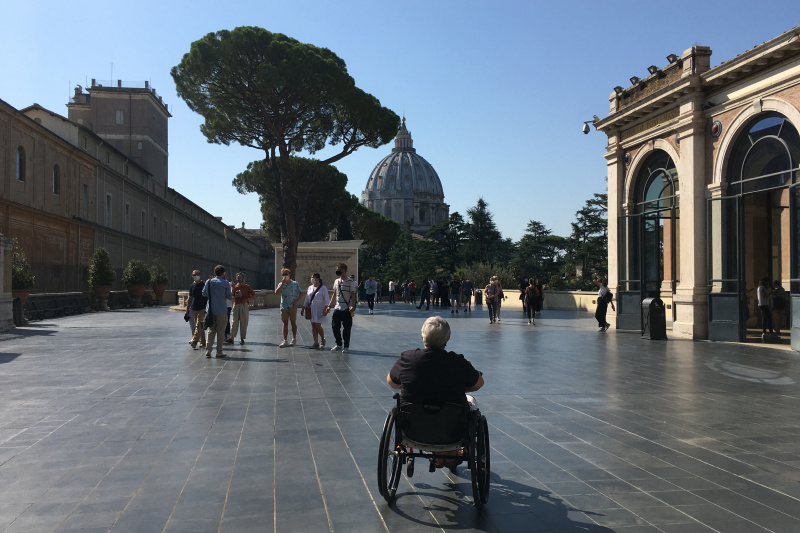 A person in a wheelchair takes a moment to relax on a terrace of the Vatican
