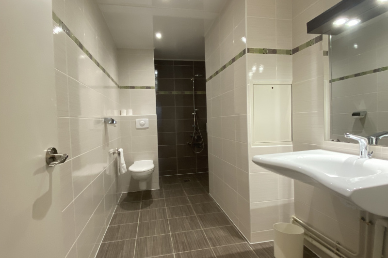 The Campanile Hotel triple room ensuite bathroom has a roll-in shower