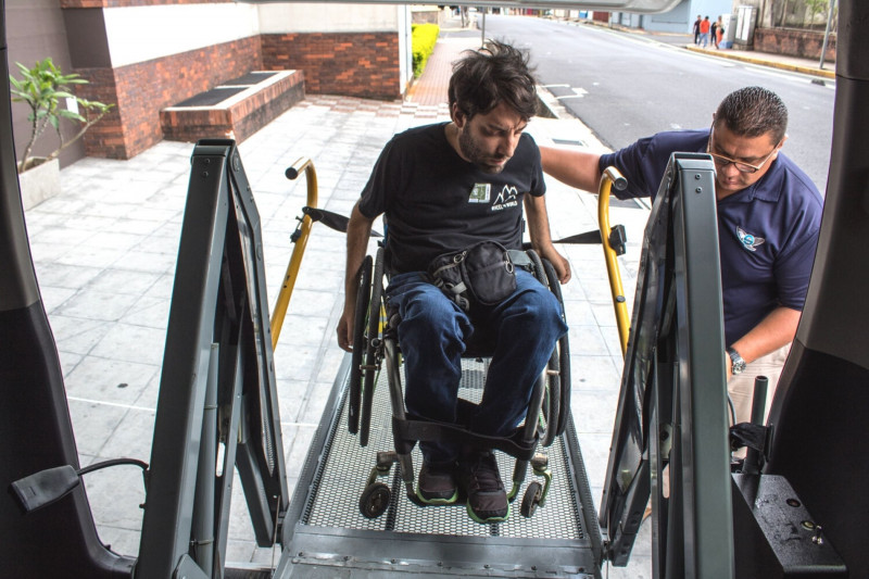 A wheelchair user is accessing the van through the lift