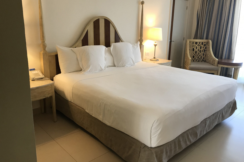 King bed with bedside tables and refined decor.