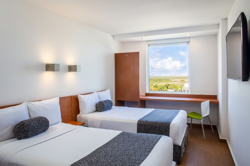 Double beds in spacious room with warm lighting