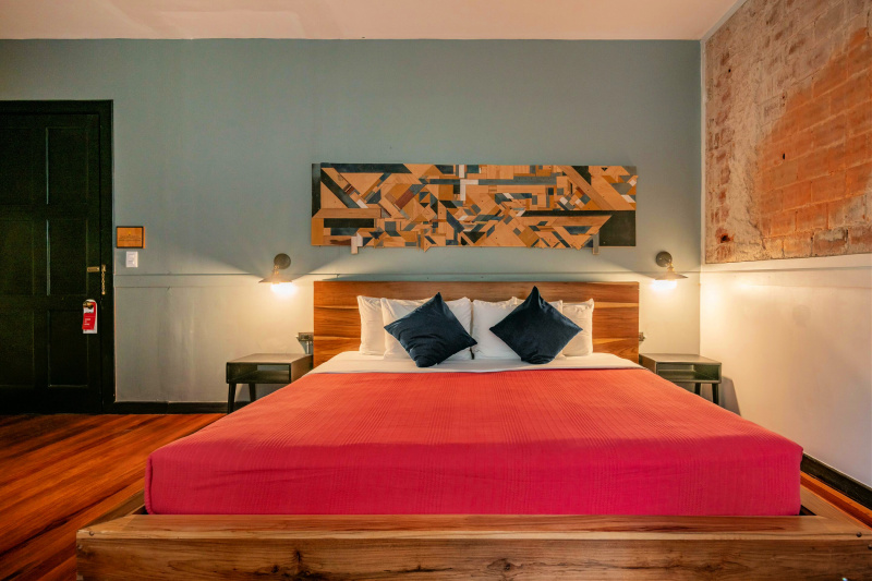 Suite with modern artistic décor and a comfortable king sized bed