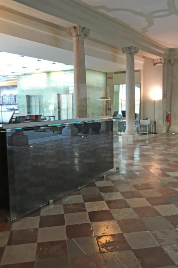 The spacious reception area has a high check-in counter with plexiglass screen protection.