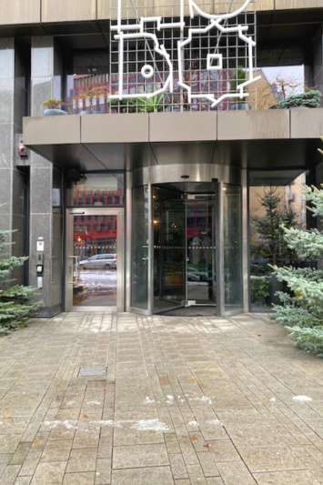 HOBO Hotel entrance has a revolving door and stone tiled entrance
