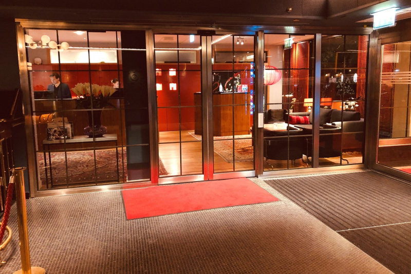 Hotel Rival Lobby a modern red monochromatic interior design, a check-in desk, and a variety of seating options