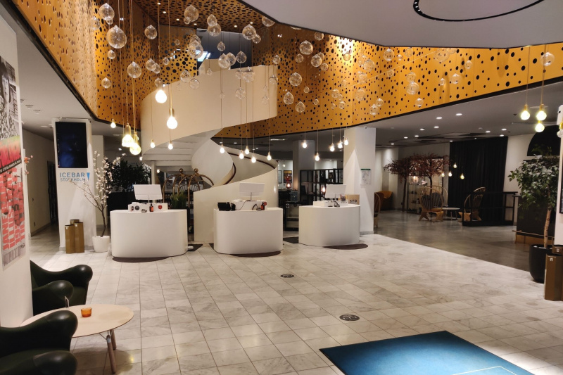 Lobby with upscale seating, chandelier, smooth floors, and circular stairwell