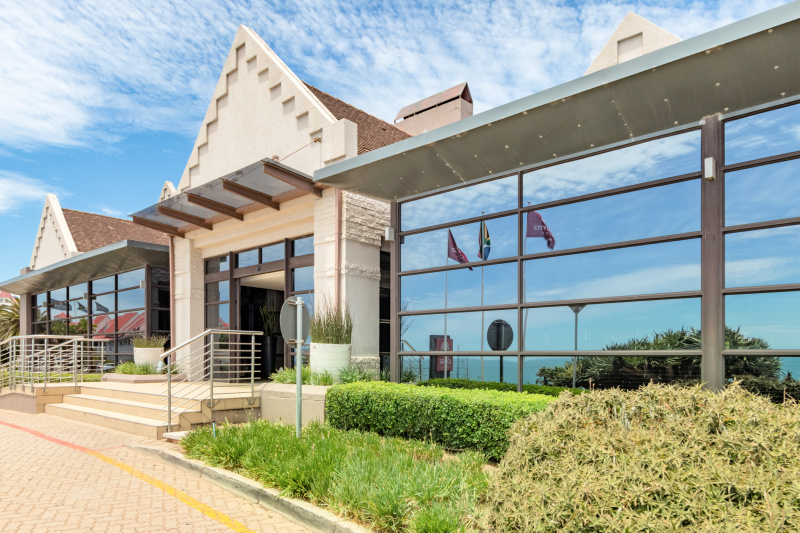 City lodge hotel with stairs, ramped entryway, and stunning ocean views