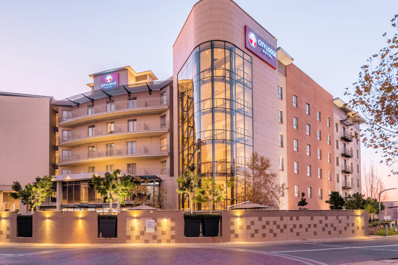 City lodge hotel exterior with large glass windows
