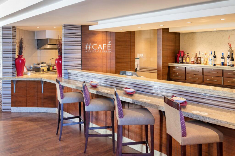Cafe with bartop seating and open kitchen