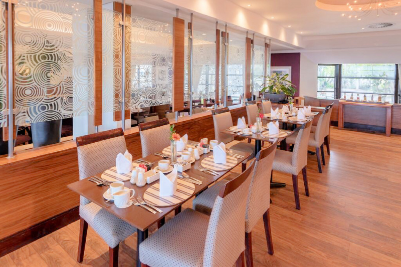 Dining tables with table settings placed at an accessible height