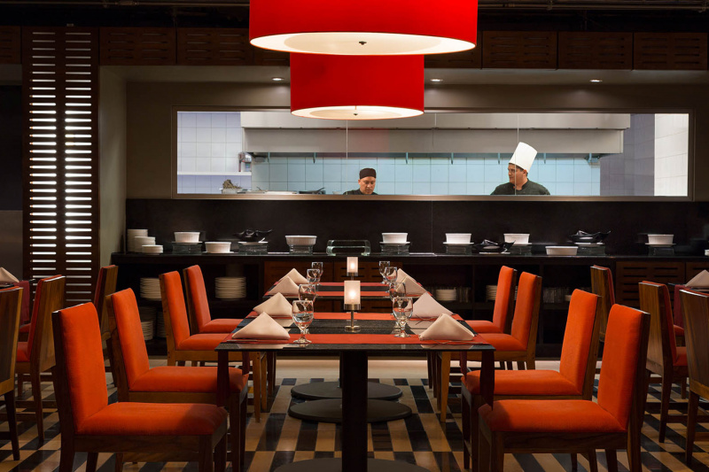 Hotel dining space with open kitchen