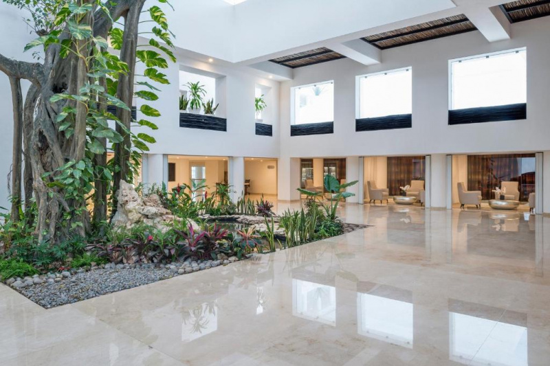View of the spacious lobby with many windows and plants