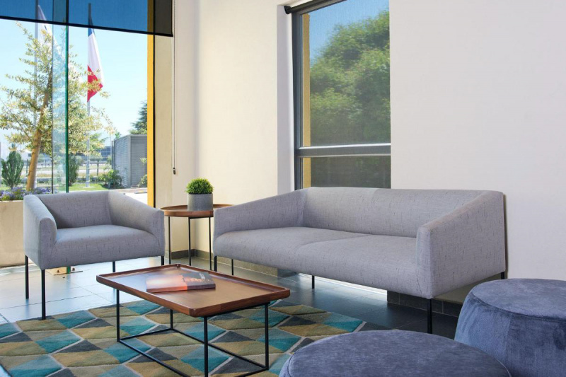 Lobby with sofas. Tile floor with carpets.