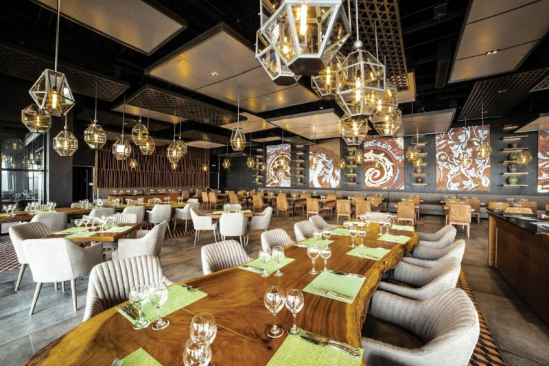 Restaurant dining room with large tables and armchairs