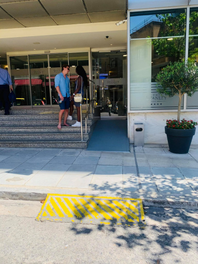 Stairs and a ramp at the hotel entrance.
