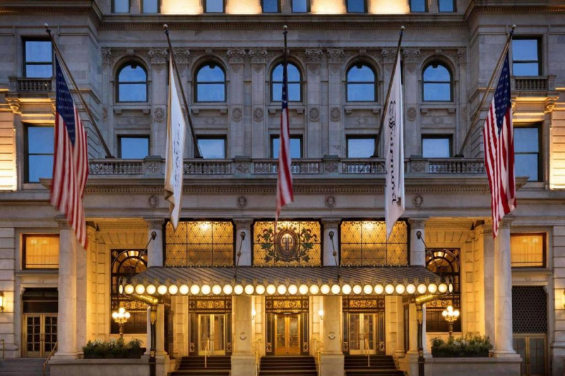 Hotel facade with entrance and flags