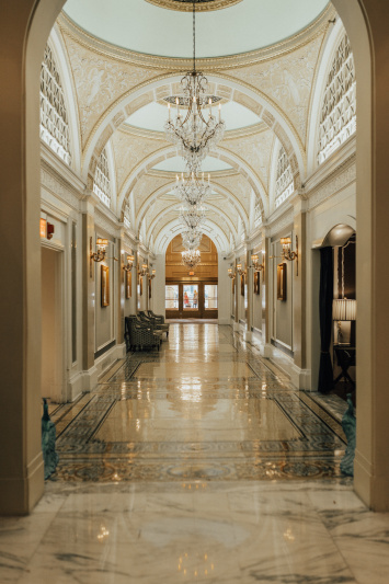 Entrance hall with marble floor and chandeliers