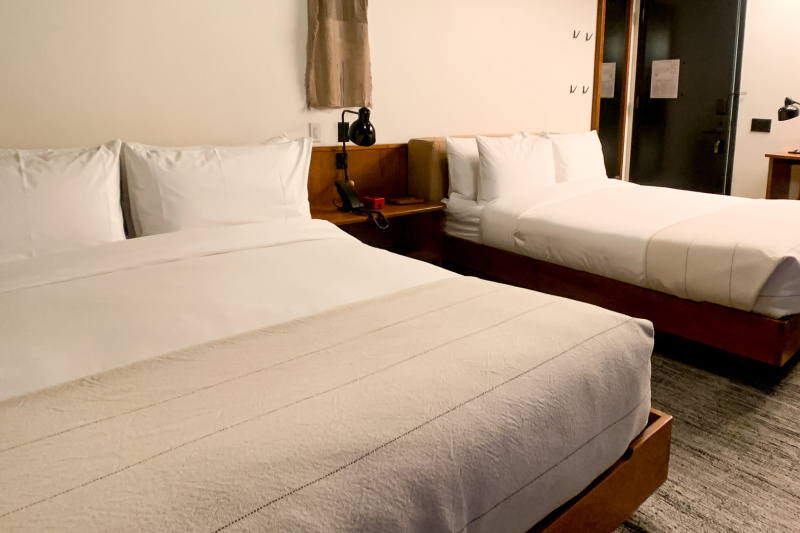 Guestroom beds separated by nightstand