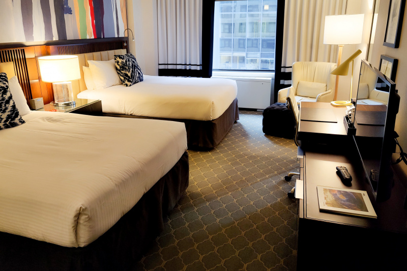 Guestroom with beds and armchair