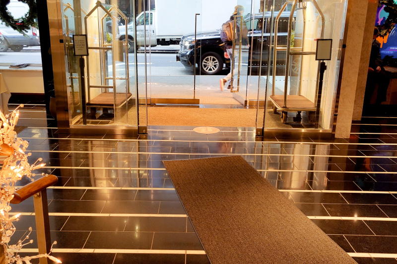 Hotel entrance and lobby area with tiled floor