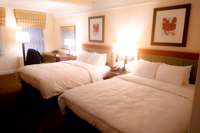 Guestroom beds separated by nightstand