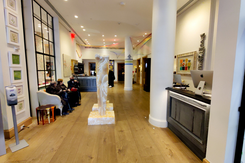Lobby area with wooden flooring and art installations