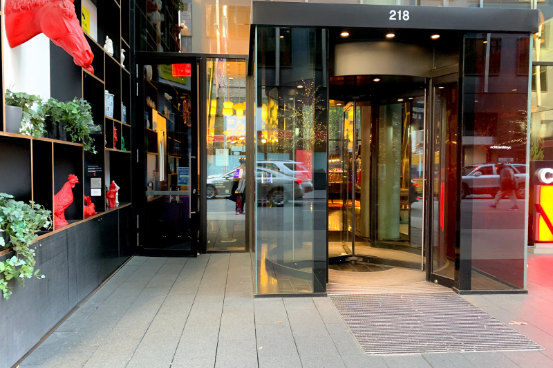 Lobby entrance with glass doors and revolving doors