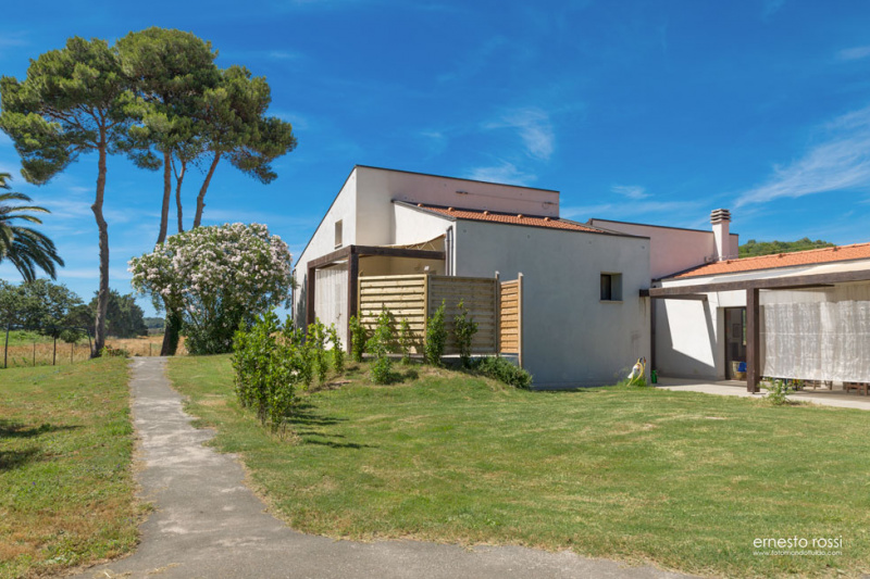 View of the house from outside. The accommodation is surrounded by grass and a pathway