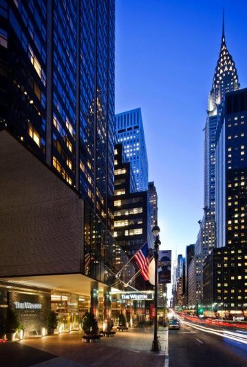 Hotel building by night with covered entrance