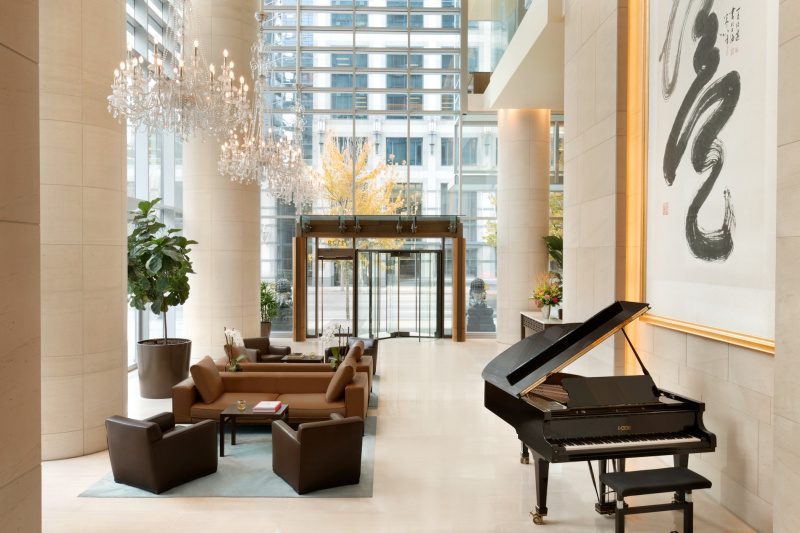 Spacious main lobby with seating areas and a piano