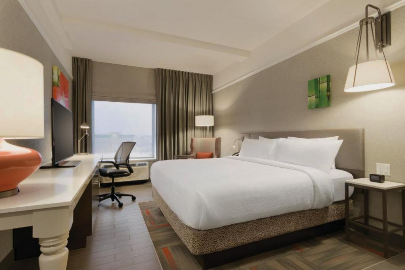 King room with a desk, flat-screen TV, and seating area by the window
