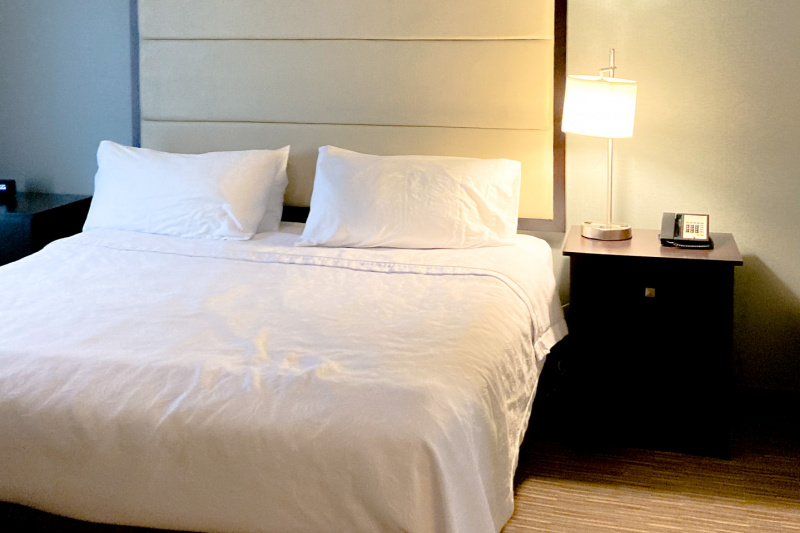 Wide space around the king-sized bed in the bedroom