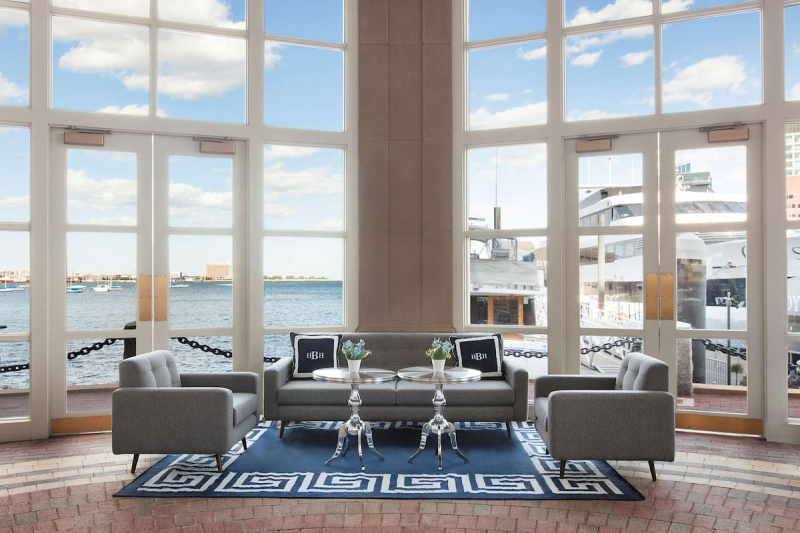 Lobby featuring a seating area and panoramic windows with views of the river