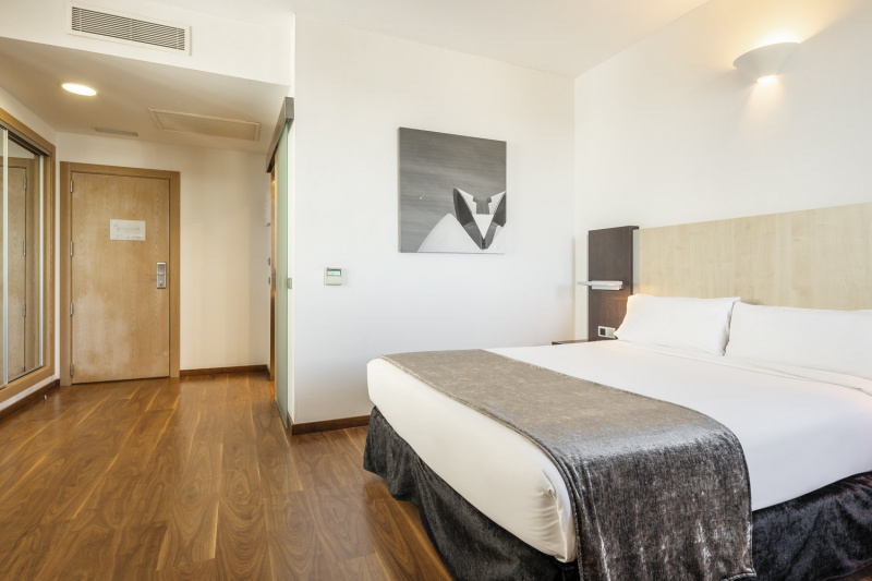Guestroom with bed and artwork
