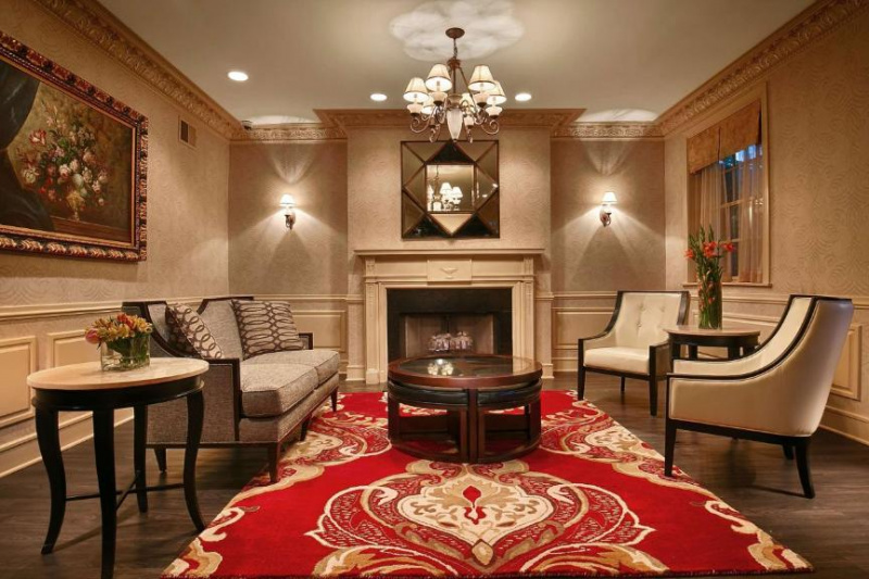 Carpeted seating area with fireplace