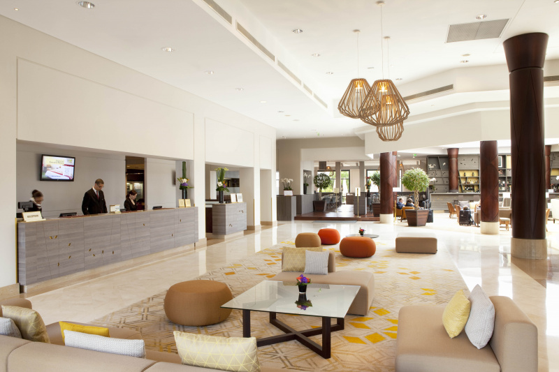 Modern lobby area with front desk and seating areas