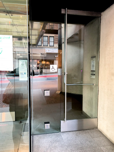 Accessible button-operated entrance door