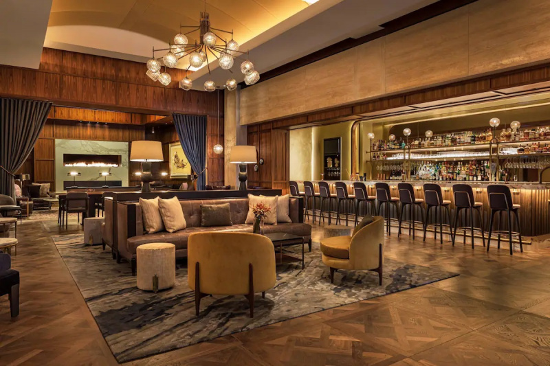 The bar area is huge. There is a long, high bar with chairs to one side. The middle of the room has sofas and chairs.