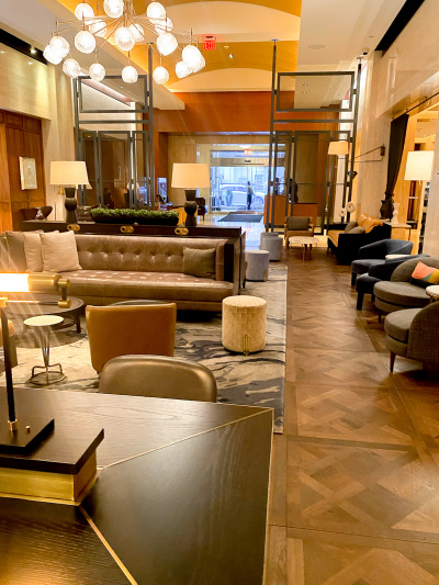 The lobby seating area has multiple chairs and sofas and is step-free.