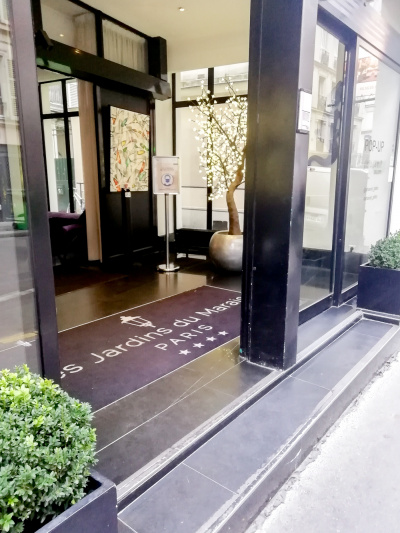 The main entrance to the hotel, which has a step and a large double door