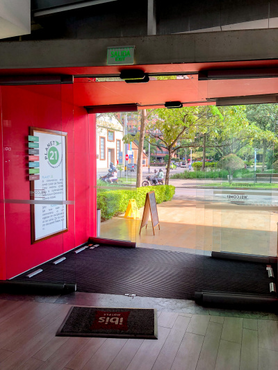 Hotel entrance with automatic double doors seen from the lobby