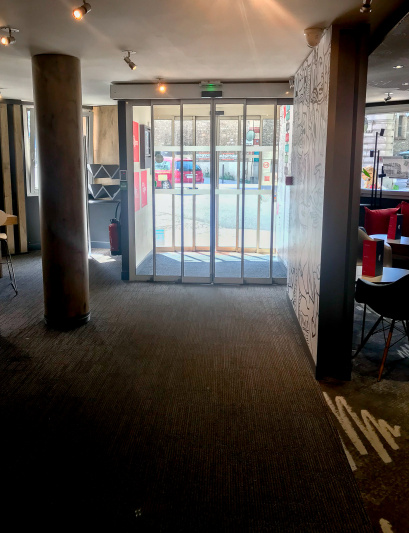 Hotel entrance with automatic doors seen from the lobby