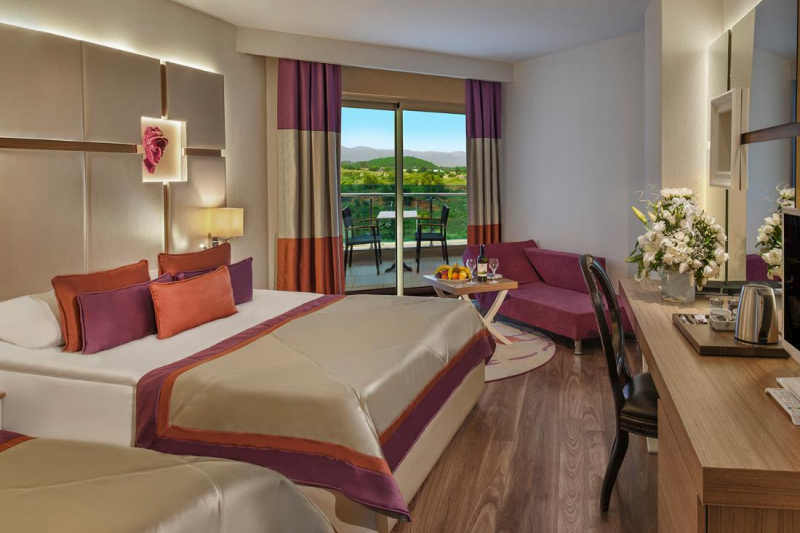 Guestroom with modern decor, seating area and balcony
