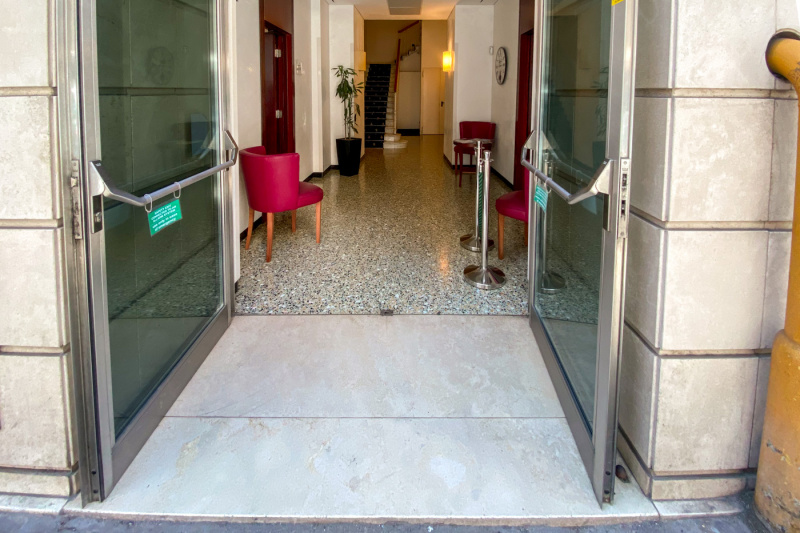 There is a very small step into the lobby.The lobby has chairs with stairs at the far end.